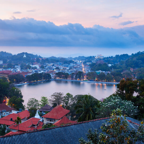 Twilight panoramic view of the city and lake seen from a balcony at the Best Kandy Viewpoint Hotel.