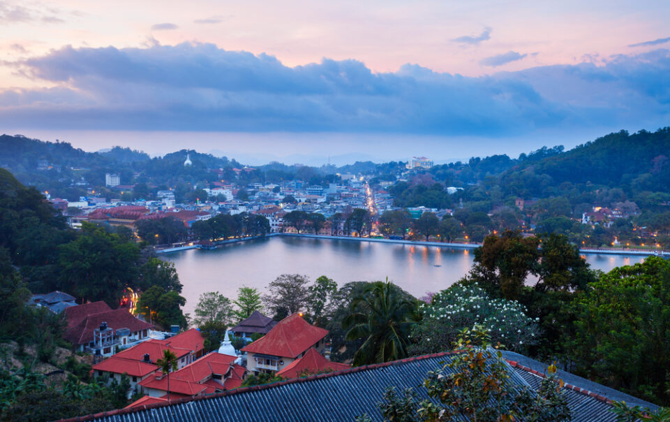 Twilight panoramic view of the city and lake seen from a balcony at the Best Kandy Viewpoint Hotel.