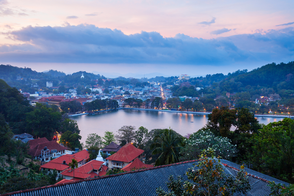 Twilight panoramic view of the city and lake seen from a balcony at the Best Kandy Viewpoint Hotel.